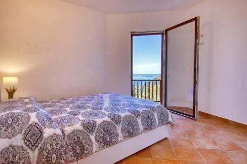 a bedroom with a bed and a view of the ocean at Stella Marina- Luxury Sea View in Porto Cervo! in Porto Cervo