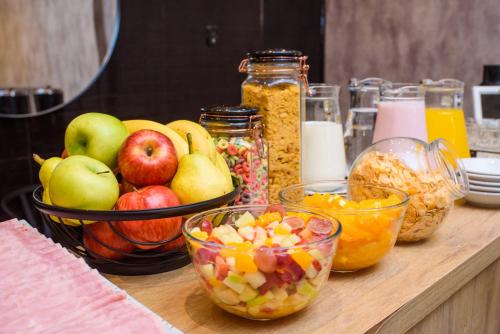 a table topped with bowls of fruit and other foods at 1253 Recoleta Small Hotel in Buenos Aires