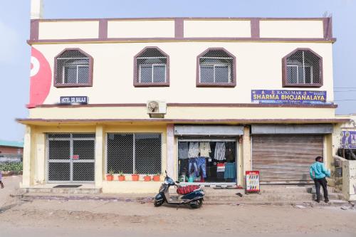 a scooter parked in front of a building at OYO Hotel Shree Balajee 1 in Puri