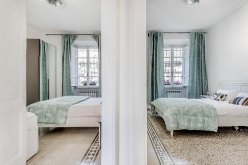 1 Schlafzimmer mit 2 Betten und 2 Fenstern in der Unterkunft Trastevere’s Flower 