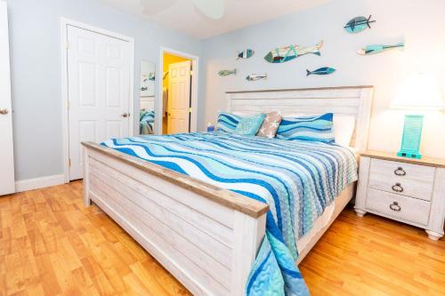 a bedroom with a bed with a blue and white comforter at Ocean Glass Condominiums in Rehoboth Beach