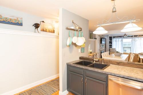 a kitchen with a sink and a dining room at Ocean Glass Condominiums in Rehoboth Beach