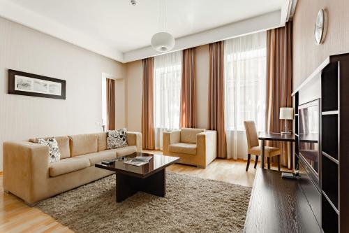 a living room with a couch and a table at Senator Victory Square in Kyiv