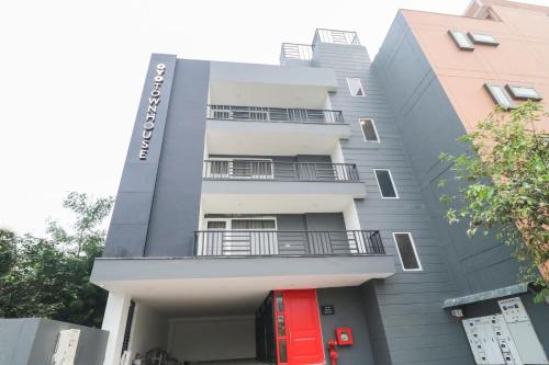 a building with a red door in front of it at OYO Townhouse 588 Noida Sector 71 Near ISKCON Temple Noida in Indirapuram