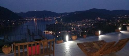 a balcony with a view of a city at night at Holiday Home Vista Lago in Cernobbio