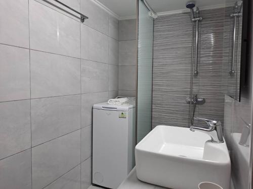 a bathroom with a toilet and a sink and a shower at Cozy Apartment in Nea Palatia-Oropos in Oropós