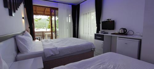 Postel nebo postele na pokoji v ubytování KAPTAN HAN Boutique hotel