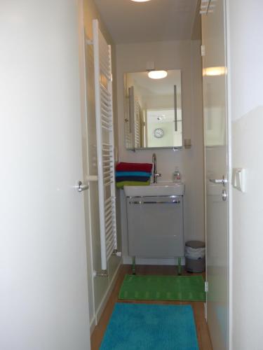 a small bathroom with a sink and a mirror at Houseboat In The Center, 5 min walk to Tropical Museum, Free Wifi! in Amsterdam
