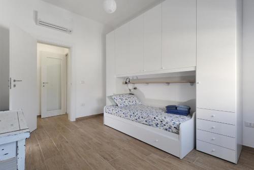 a white bedroom with a bunk bed and a closet at [Relax-Comfort-Home] City Center in Porto Torres