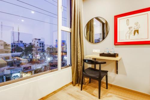 a room with a desk and a window with a view at Super townhouse moosapet Rcc Prime in Hyderabad