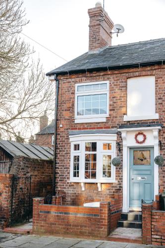 a brick house with a blue door at Quaint Georgian house with Parking & Huge Garden 10 mins walk from town in Shrewsbury