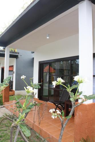 a house with a bench on a patio at D'Mell Bali in Nusa Dua