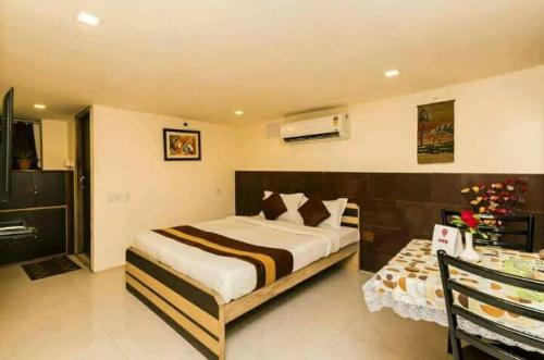 a bedroom with a large bed and a desk at Collection O Church View Near St. Thomas's Church in Kolkata