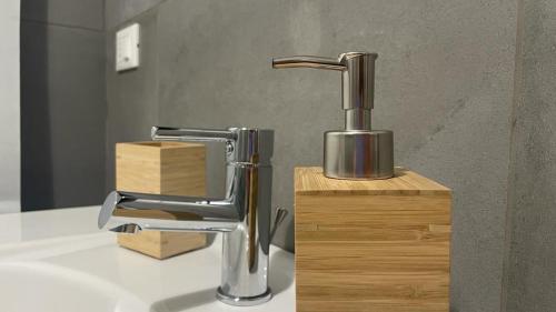 a bathroom sink with a chrome bathroom faucet at Doctor House standard, suites & luxury rooms in Enna