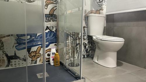 a bathroom with a white toilet in a room at Doctor House standard, suites & luxury rooms in Enna