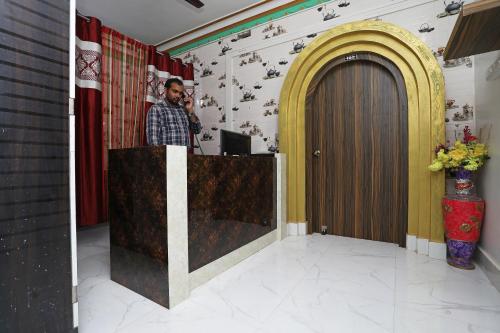 a man standing at a podium in a room at OYO Aradhya Residency in Bhubaneshwar