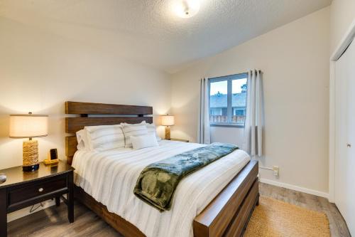 a bedroom with a bed and a desk and a window at Walk to Seaside Beach Vacation Rental Cottage! in Seaside