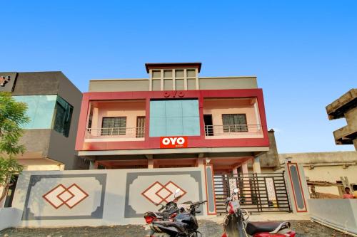 a row of motorcycles parked in front of a building at OYO Raj Hotel in Nagpur