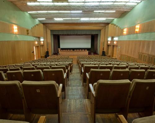 an empty lecture hall with chairs and a projection screen at Hetman Hotel in Lviv