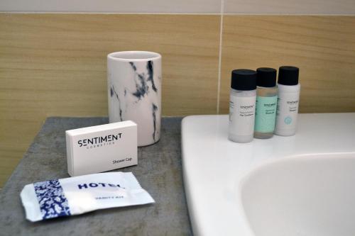 a bathroom with a sink and some products on it at Sweet Retreat in Paralimni
