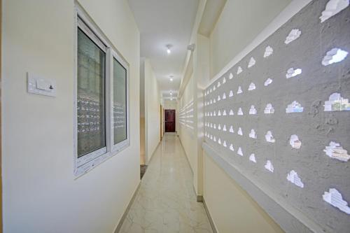 a hallway with a wall with footprints on it at Vsv Guest House in Chennai