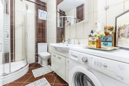 a bathroom with a sink and a washing machine at Modern Flat with Balcony in Uskudar in Istanbul