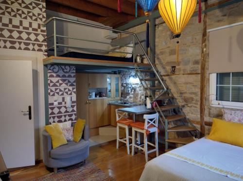 a bedroom with a bunk bed and a kitchen at Mastixi in Chios
