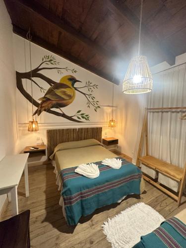 a bedroom with a bird painted on the wall at Casa Yuri in Salta