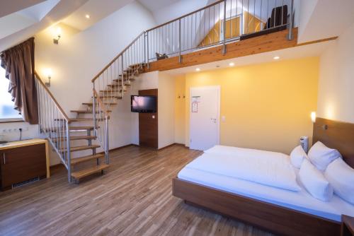 a bedroom with a large bed and a staircase at Altstadthof Freinsheim in Freinsheim