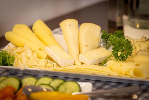 a plate of cheese and vegetables on a table at Altstadthof Freinsheim in Freinsheim