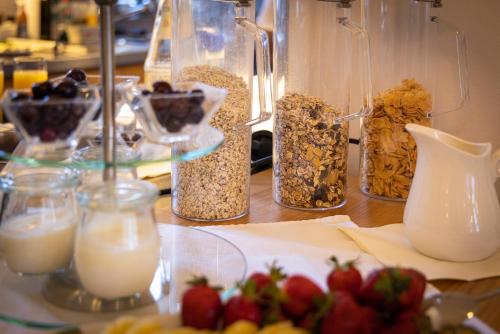 a table with several jars of granola and milk at Altstadthof Freinsheim in Freinsheim