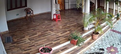 an overhead view of a wooden floor in a house with plants at SERENE Stays - Kjsb farmhouse THANJAVUR in Thanjāvūr