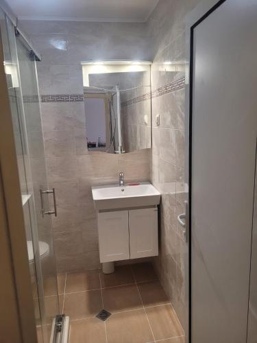 a bathroom with a white sink and a shower at Sozopoli Hills, app B7 in Sozopol