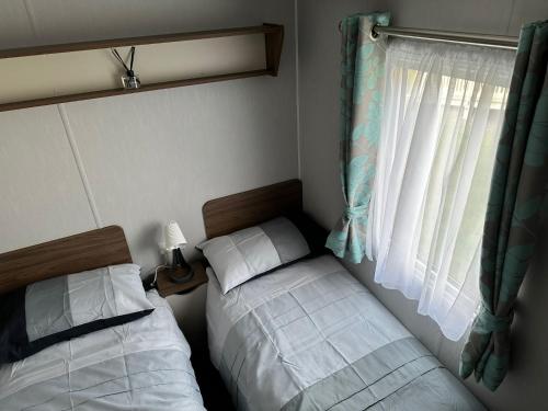 a bedroom with two beds next to a window at Seton Sands St Andrews in Port Seton