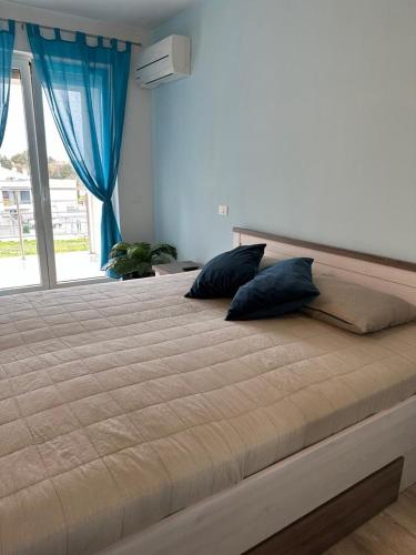 a large bed with two pillows in a bedroom at Volme Resort in Banjole