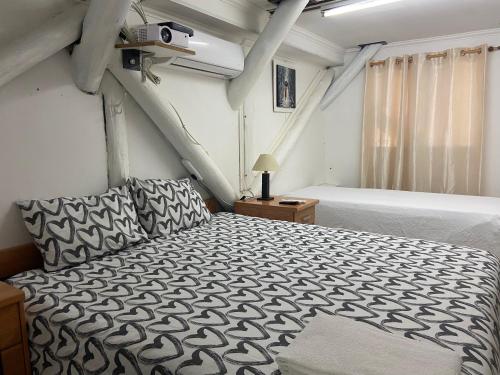 a bedroom with a bed with a black and white comforter at Monoambiente Playa Nebel in Concordia