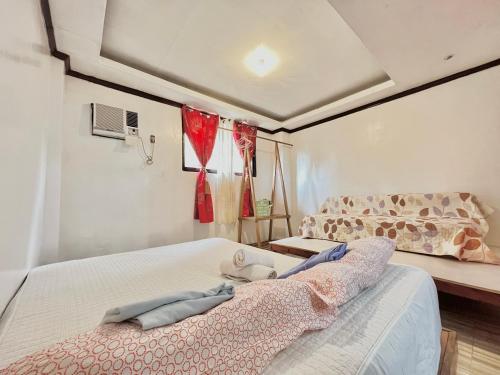 a bedroom with two beds and a bed sqor at Precious Homestay -Suite Room in Burgos