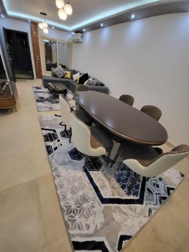 a meeting room with a table and chairs on a rug at Royal Residence 3 New 2 bed apartment sea view with infinity pool in Sharm El Sheikh