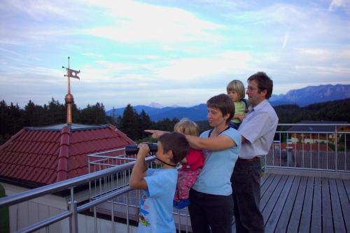 a man taking a picture of a group of children at Hotel Irmgard in Strass im Attergau