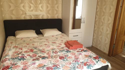 a bedroom with a bed with a floral comforter at Jurmala's Centre Apartments in Jūrmala