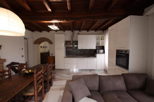 a kitchen and living room with a couch and a table at casa airuno in Airuno