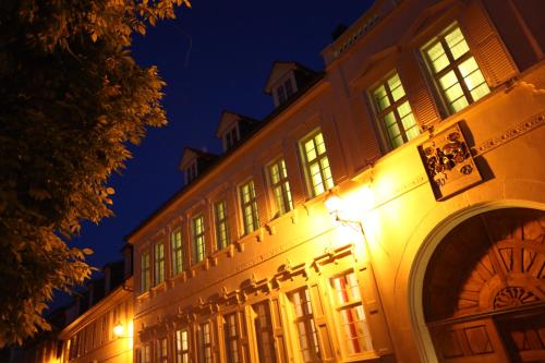 a building with lights on the side of it at night at Altstadthof Freinsheim in Freinsheim
