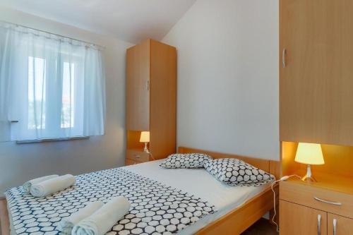 a bedroom with a large bed with two pillows at Linde in Nerezine