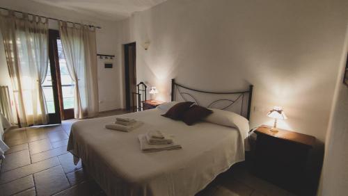 a bedroom with a bed with two towels on it at Agriturismo Vallerana in Capalbio