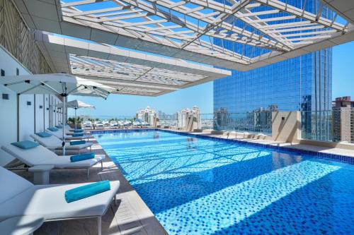 a swimming pool on top of a building at Cheval Maison - The Palm in Dubai