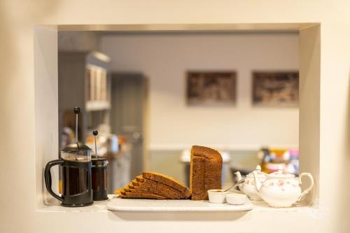 a kitchen counter with bread and a tea kettle at Burlington House Boutique in Oxford
