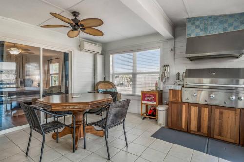 a kitchen with a table and chairs and a ceiling fan at Harbor Island 2 Ebb Tide Ct in Oceanmarsh Subdivision