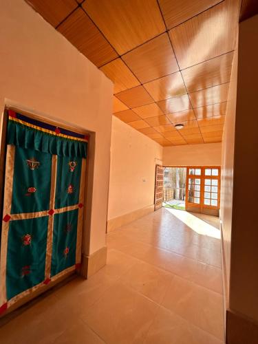 a room with a curtain on a wall at Zambala guest house in Leh