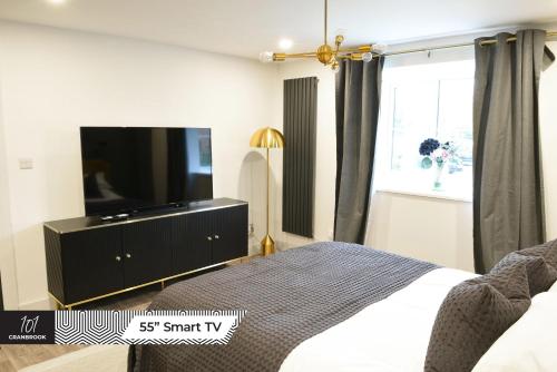 um quarto com uma cama e uma televisão de ecrã plano em Newly Refurbished Luxury Hotel Style Accommodation em Milton Keynes
