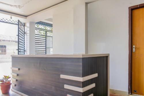 an office lobby with a wooden reception desk at Welcome Inn Near DN Regalia in Khandagiri